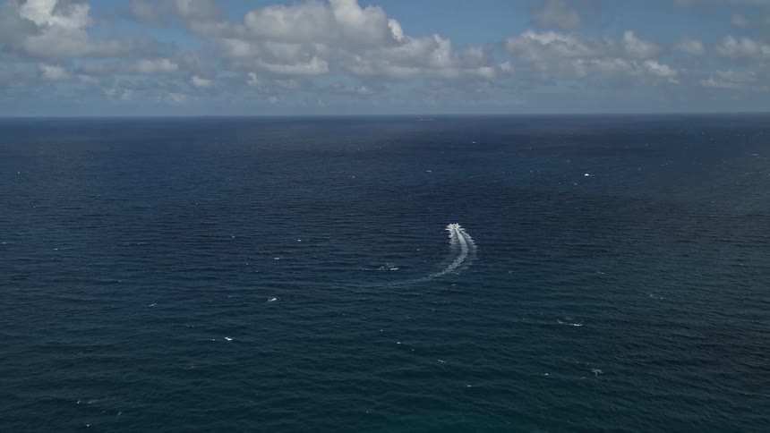 A speedboat cruises across the Atlantic Ocean at Pompano Beach Florida offering a lovely recreation and transportation experience amidst the sunny and relaxing atmosphere of the East Coast
