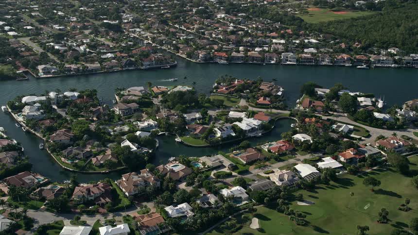Upscale residential neighborhood in Boca Raton Florida captured in stunning 5K aerial footage with waterfront mansions and canals