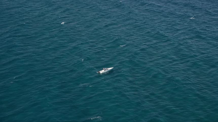 Approaching a speedboat creates waves as it cuts through the open waters of Boynton Beach Florida during summer