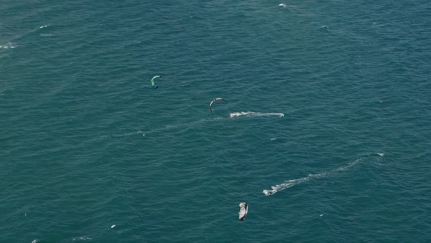 Aerial footage of kite surfers enjoying the spring or summer sunshine off the coast of Delray Beach Florida