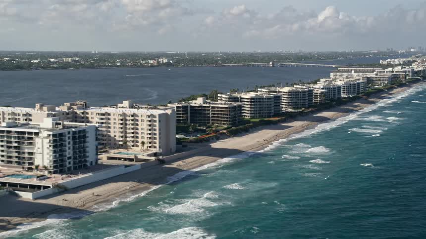 A stunning aerial view of coastal apartments and condominiums along Palm Beachs beachfront