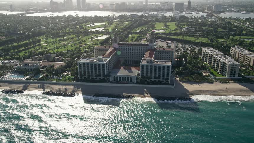 This aerial footage captures The Breakers Palm Beach a luxurious beachside resort in Palm Beach Florida surrounded by white sandy beaches and recreational activities