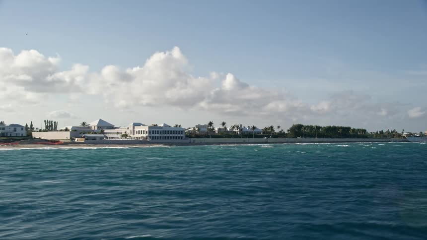 A stunning aerial view of Palm Beachs coastal shoreline with trees and buildings perfect for sightseeing recreation and leisure activities during a partly cloudy day