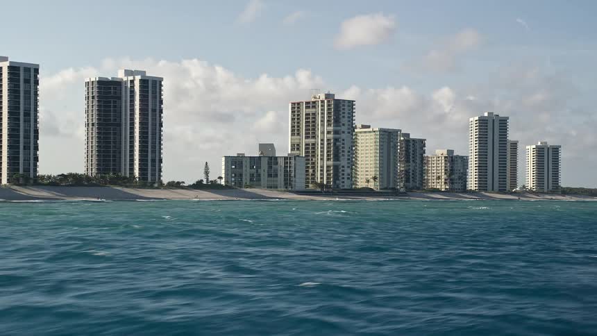 A beautiful aerial view of the beach and coastal condominiums in Riviera Beach Florida during the summer