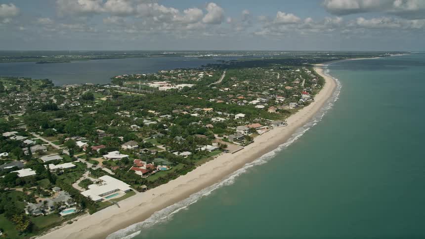 Aerial footage of a long stretch of beach that runs through residential neighborhoods in Vero Beach Florida