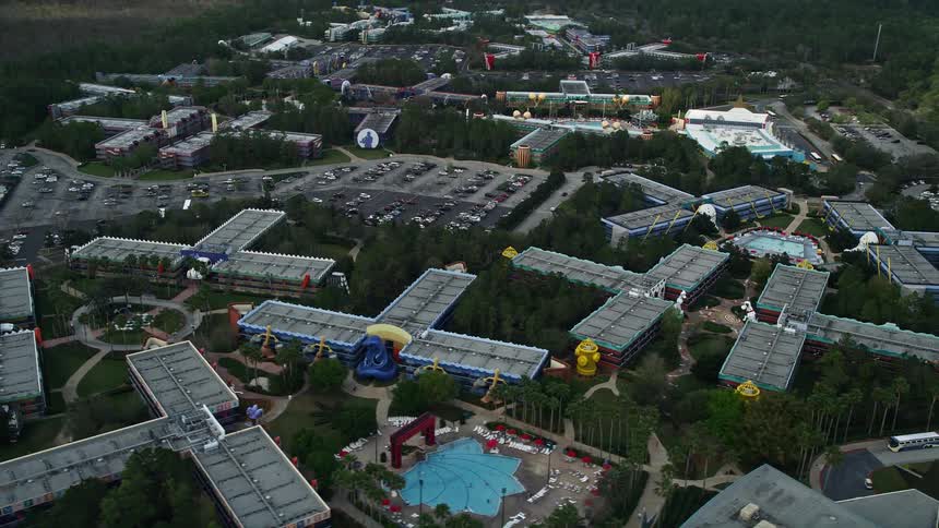 A mesmerizing aerial footage of Disneys All-Star Sports Resort as a part of an amusement park in Orlando Florida during summer with partly cloudy skies