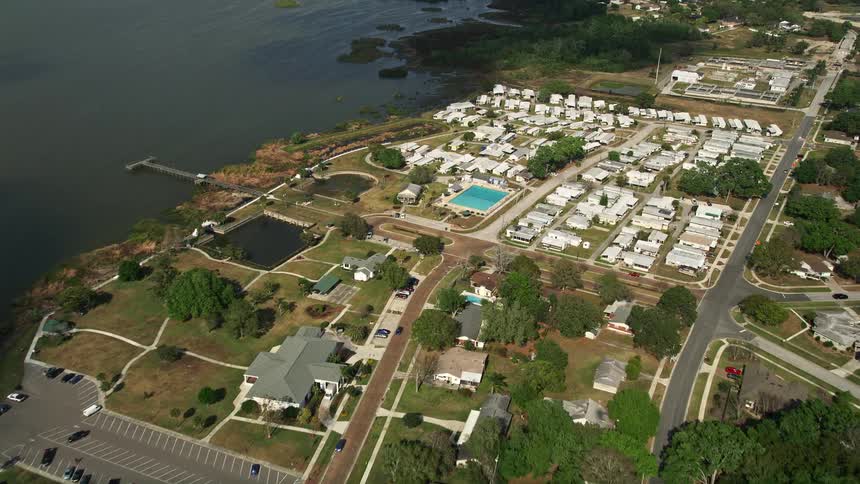 Approaching a mobile home park with RVs and residences on the shore of a lake in Winter Garden Florida
