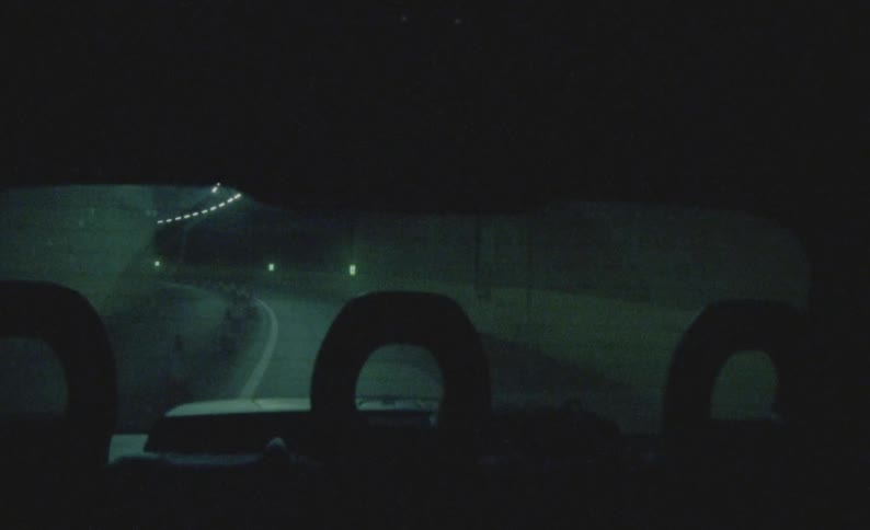 The camera captures footage of a roadway as a vehicle passing along it