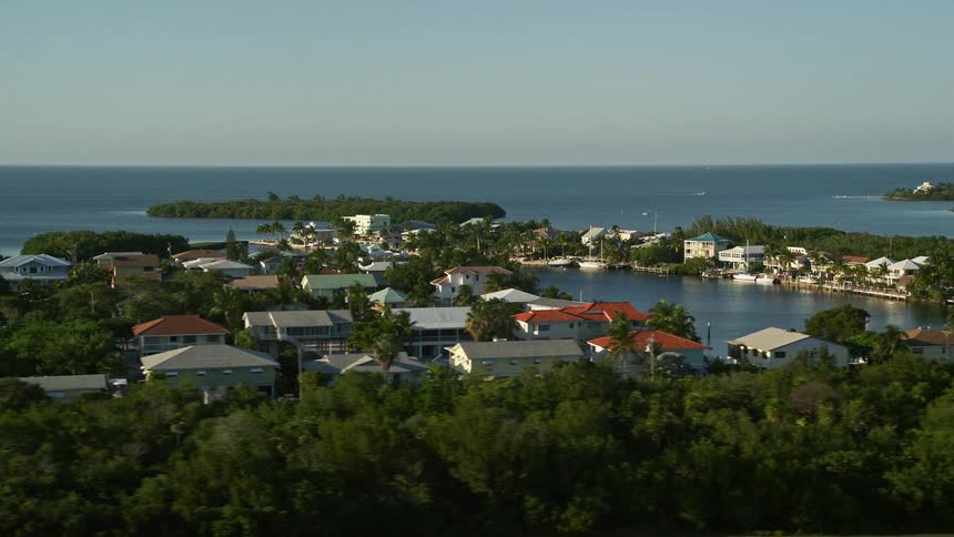 Aerial footage at sunset of houses lining the shore in Marathon Florida