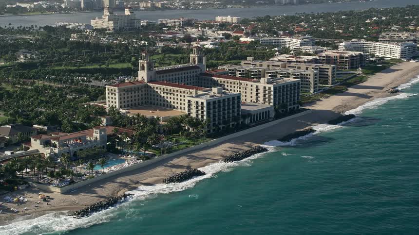 Approaching The Breakers Palm Beach Hotel on a partly cloudy day in Palm Beach Florida observed from a 5K aerial view during daytime