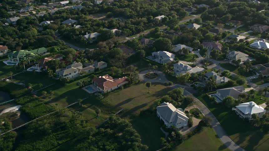 An aerial view of the suburban residential neighborhood in Stuart Florida during the evening with partly cloudy skies