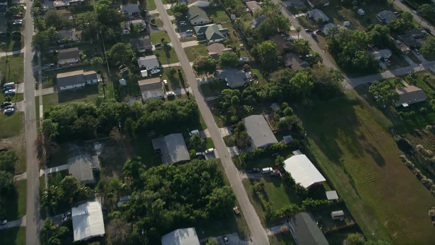 Fly over suburban Stuart Florida at dusk and get a birds eye view of the single family homes in the bedroom community