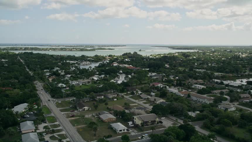 Aerial footage of residential homes and waterfront properties in a small town near Willoughby Creek Stuart Florida