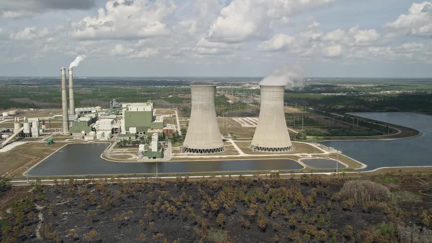 Aerial view of a coal-fired power generation facility in Orlando Florida during partly cloudy skies