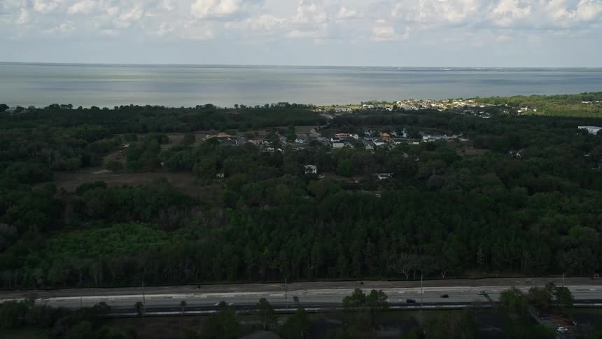 Aerial footage of a suburban neighborhood surrounded by trees near a lake in Winter Garden Florida