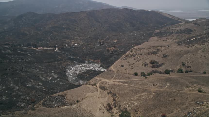Aerial footage of burned rural homes within the wildfire damage of Santa Monica Mountains California