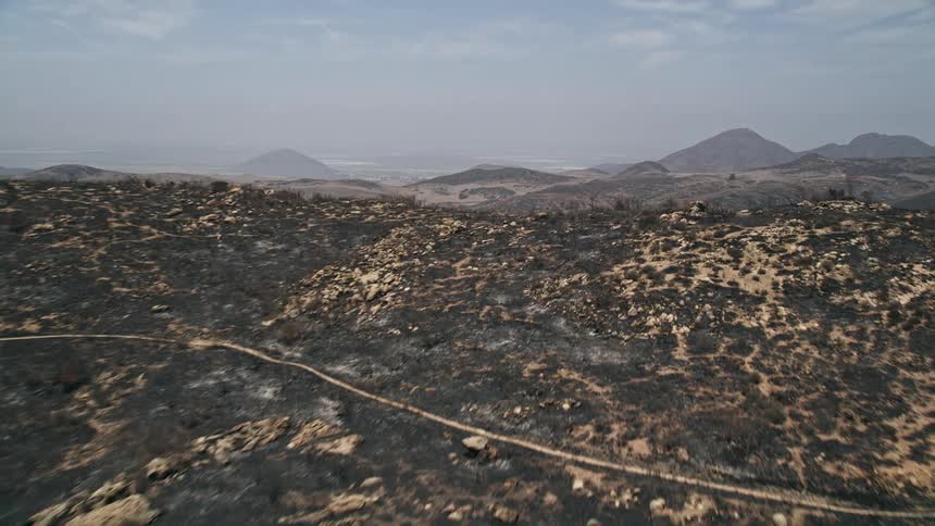 Aerial view of fire-damaged slope revealing barren Santa Monica Mountains California