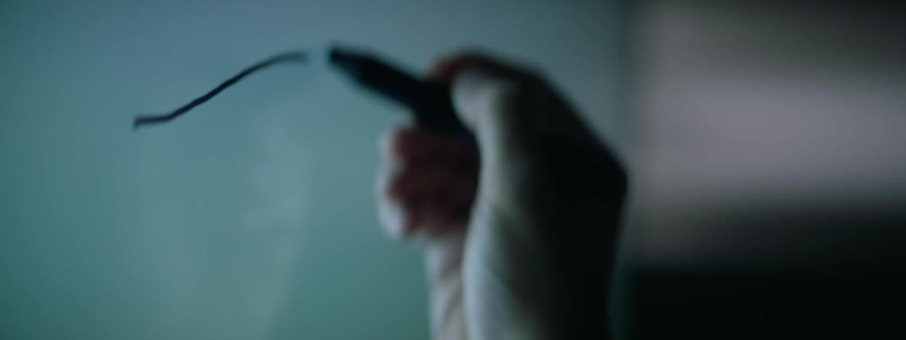 Closeup of a male hand drawing an eye on a board using a black sharpie