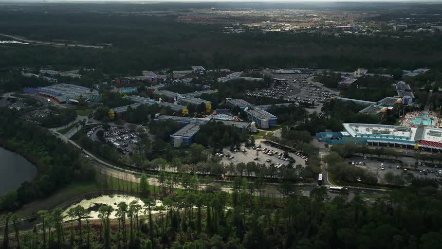 Approaching aerial view of Disneys All Star Sports Resort in Orlando Florida on a partly cloudy day perfect for sightseeing recreation and enjoyment