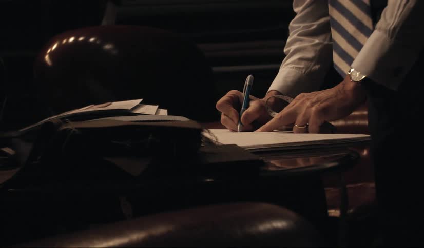 A man jots something down in a notebook