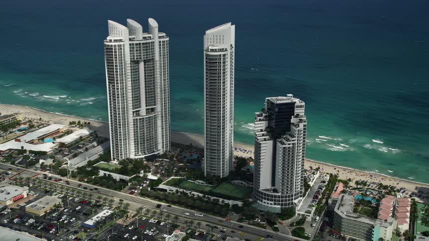A breathtaking aerial view of the luxurious Trump International Beach Resort situated on the Sunny Isles Beach with a majestic coastline and Miami cityscape in sight
