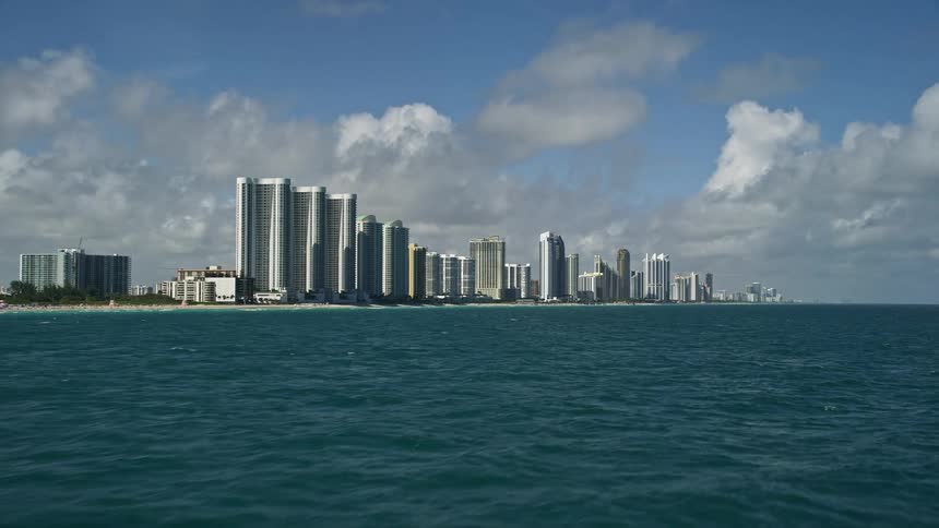 An aerial flyover of Sunny Isles Beach Florida revealing the Trump Towers on the citys coast
