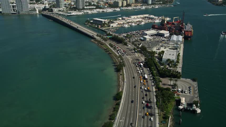 Soaring above MacArthur Causeway on a sunny day the footage reveals the stunning South Beach in Miami Beach Florida