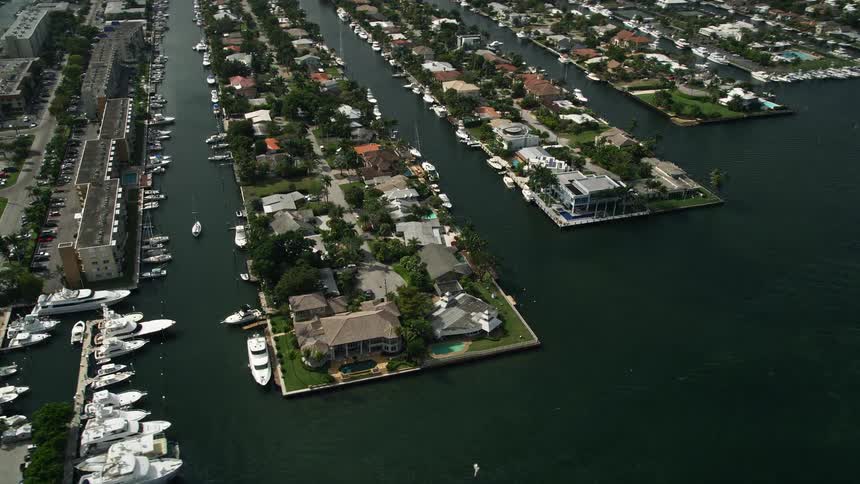 Aerial view flying by luxurious riverfront mansions in Fort Lauderdale Florida