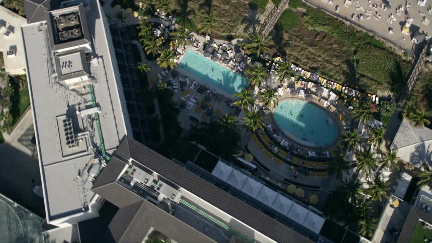 Aerial view of the pool area at Boca Raton Resort and Club on a partly cloudy day in Florida