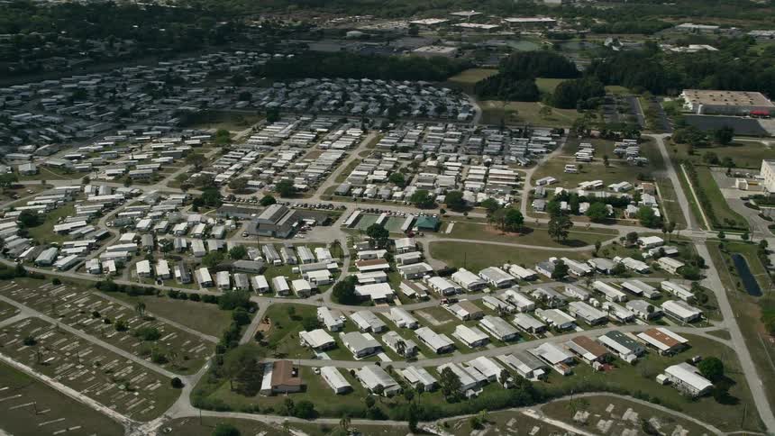 An aerial view of a mobile home park in Melbourne Florida orbiting on a partly cloudy day
