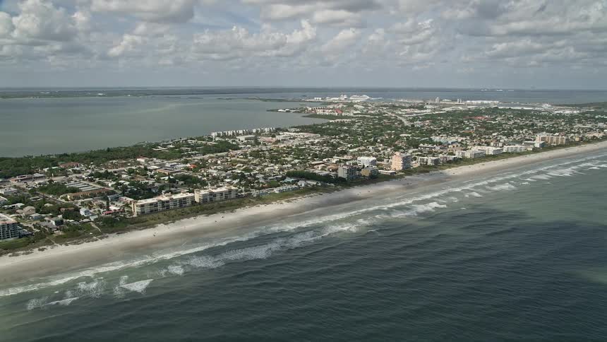 Fly over Cocoa Beach Floridas shoreline capturing stunning views of residential areas recreational beach-goers and nature in Central Florida