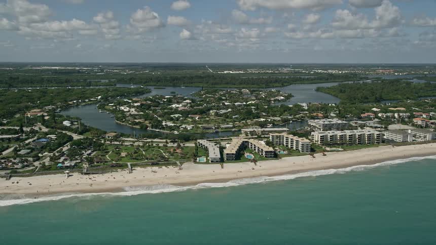 An aerial view of beachside condominiums in Vero Beach Florida with the shoreline and river in the background