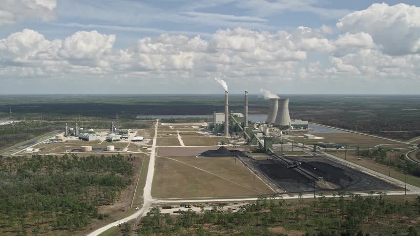 Aerial view of a coal-fired power generation facility outside Orlando Florida on a partly cloudy day