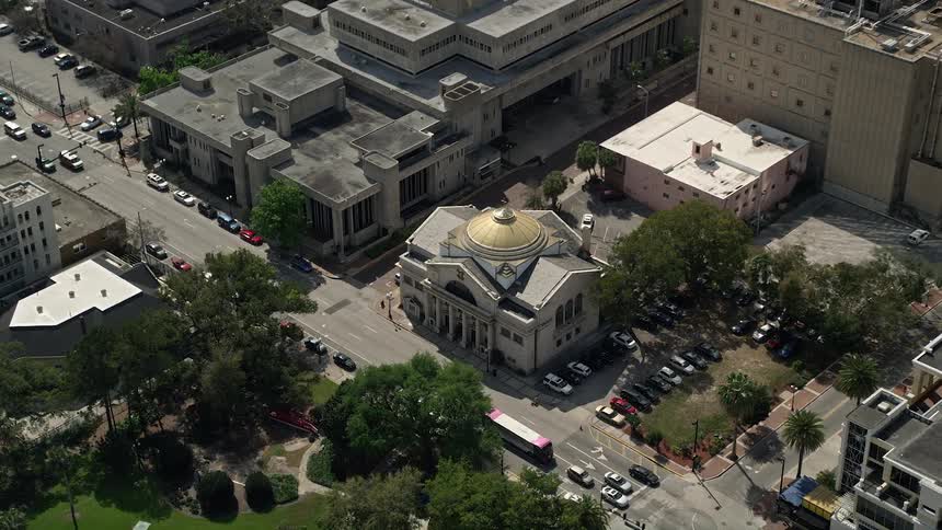 Approaching the Church of St George in downtown Orlando from an aerial with a tilt down revealing the beautiful house of worship in Central Florida