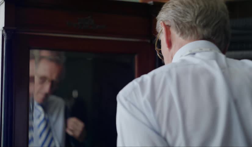 A man puts on his suit