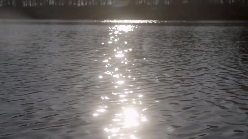 The sun reflecting in a rippling body of water