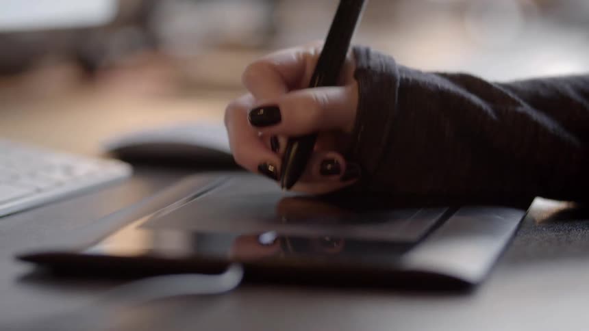 A person draws on a tablet
