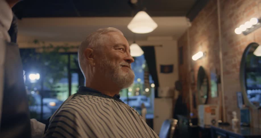 Barber spins around a client sitting on the barber shop chair