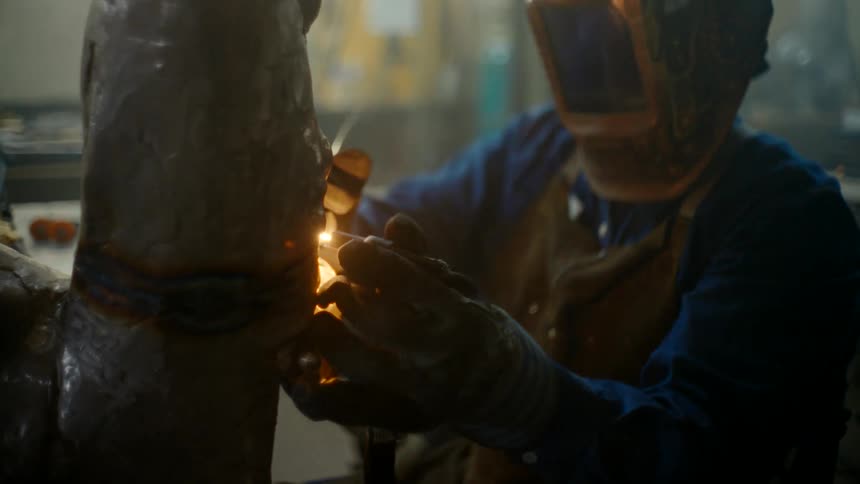 A person is welding with a torch