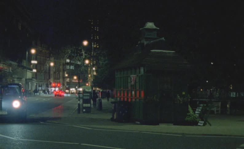 Cars and people travel in the city at night