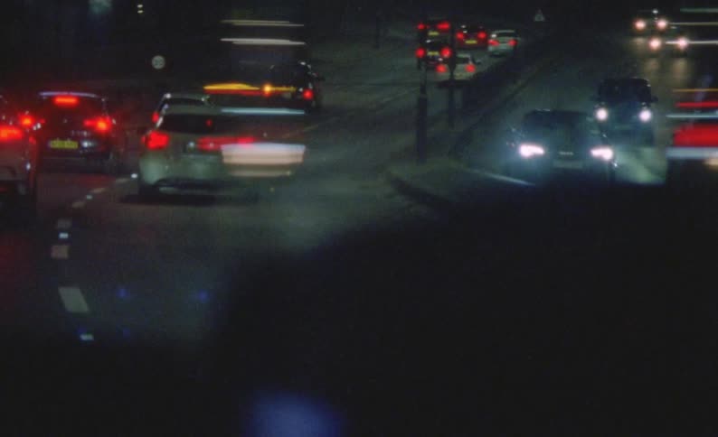 Vehicle drives along busy highway at night