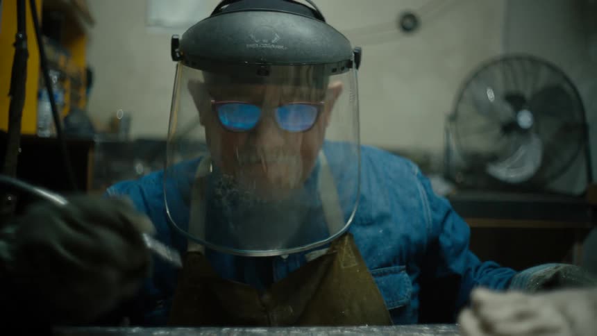 Close up of a sculptor carving a the feet of a statue in his workshop