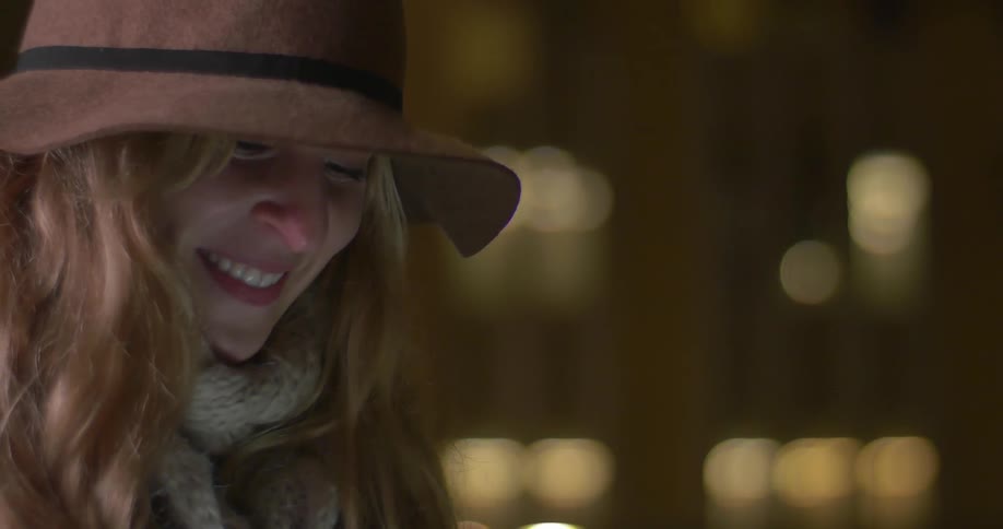 A woman standing outside at night and smiling
