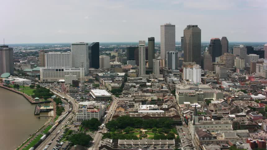 An aerial of a dense metropolis and suburban neighborhood next to a river