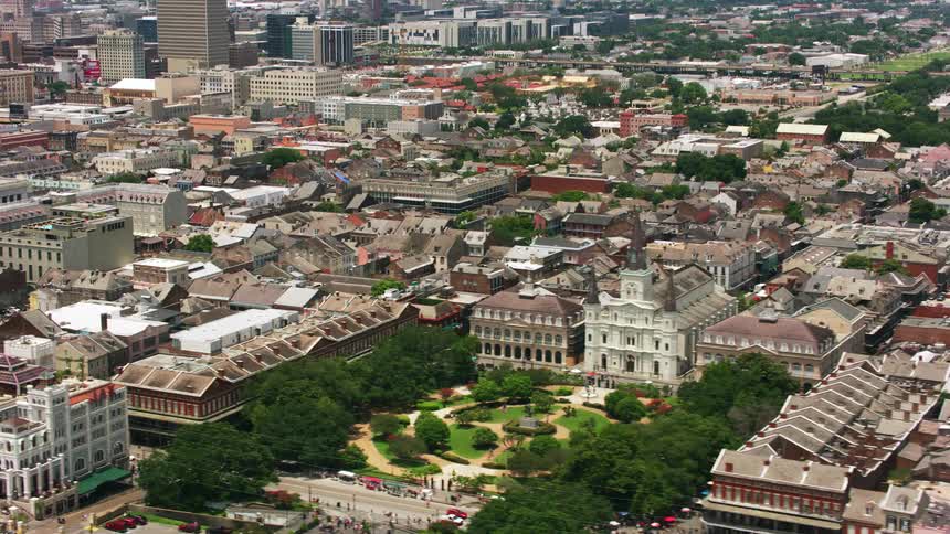 An aerial of a suburban neighborhood with houses and buildings with a courtyard in the front