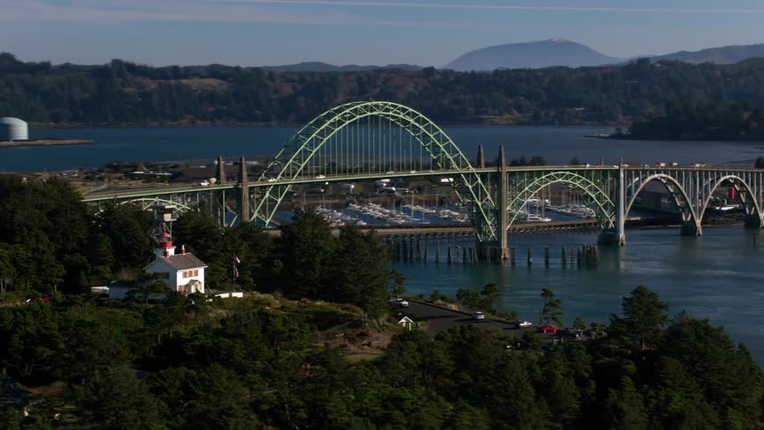 Cars and trucks traveling across the yaquina bay bridge in oregon
