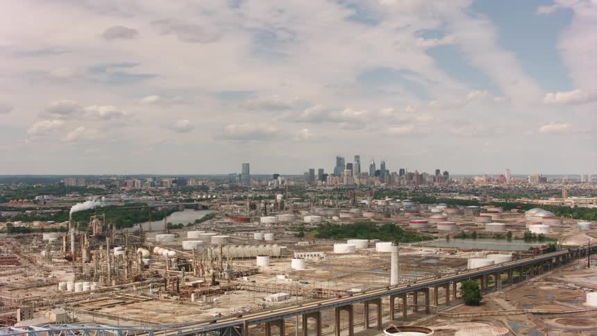 Aerial view of the industrial area next to the city skyline at daytime