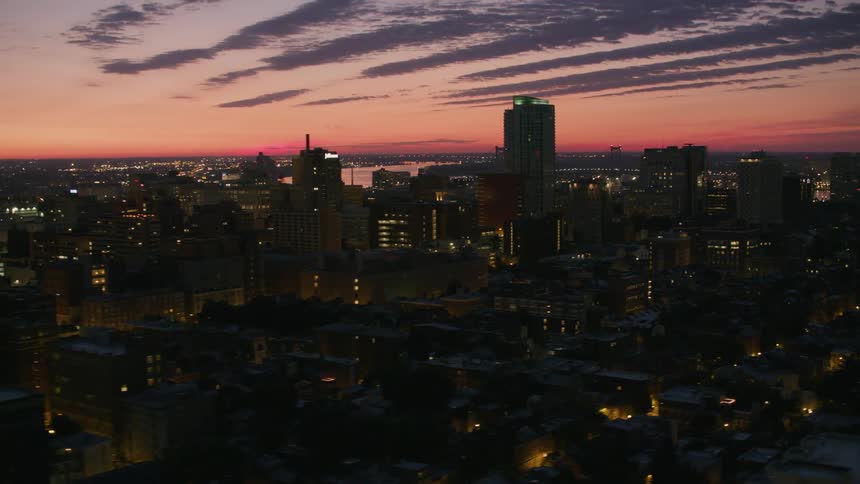 Tall buildings and skyscrapers in a metropolis at sunset