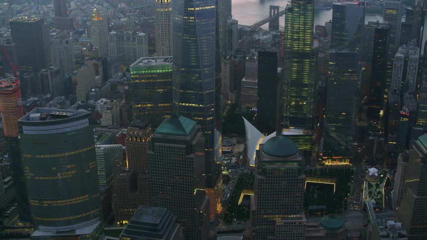 An aerial of city buildings skyscrapers and a river skirting the city