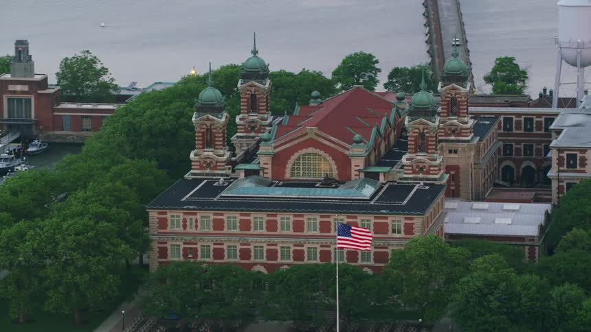 A fancy building is shown on an island surrounded by greenery